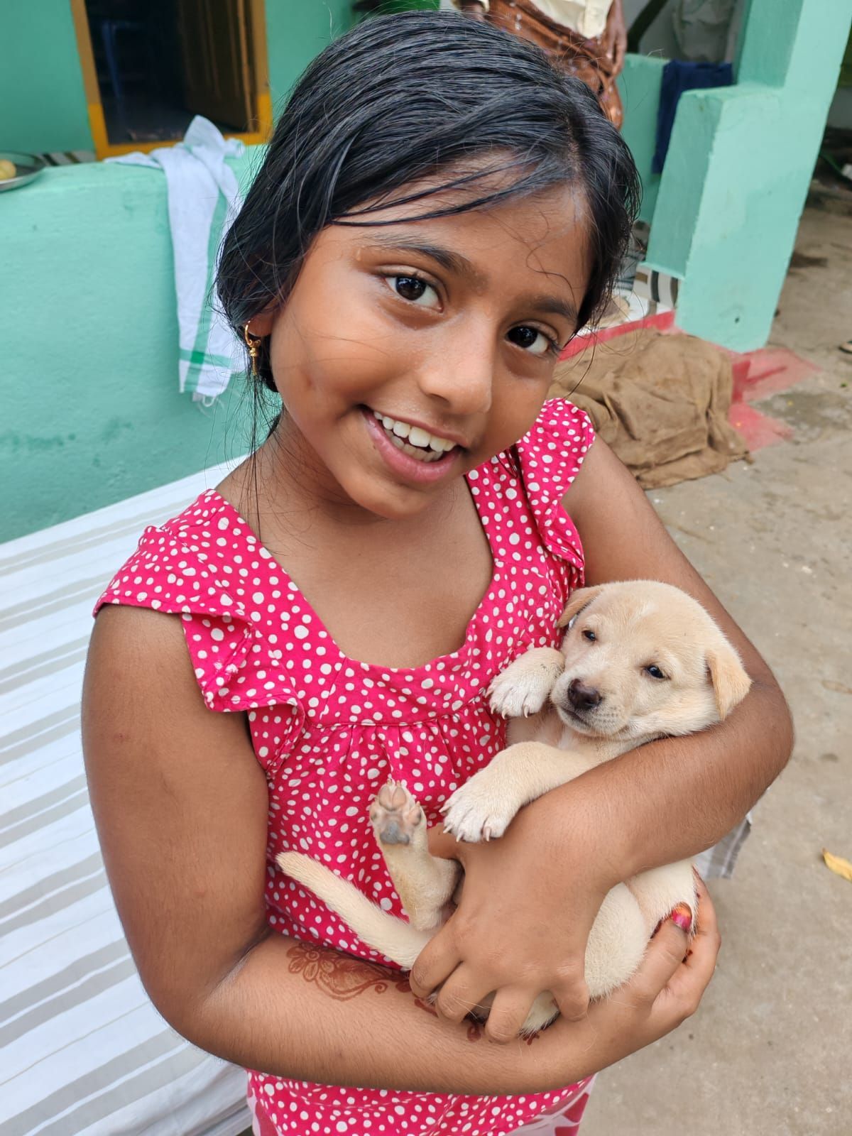 Vishal's daughter holding Don the puppy — the dog that started it all